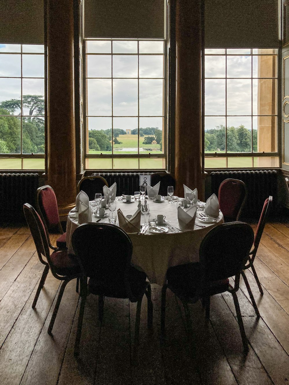 a table set for a formal dinner in a large room