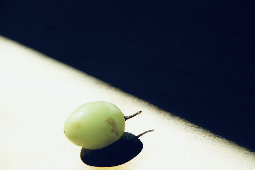 a close up of a green fruit on a table