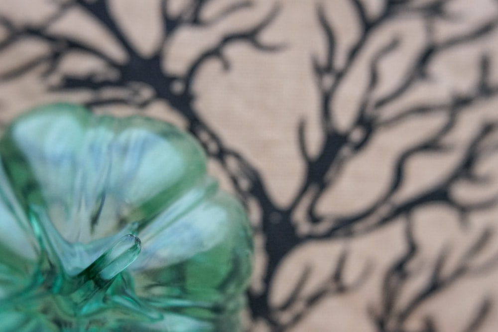 a green vase sitting on top of a table