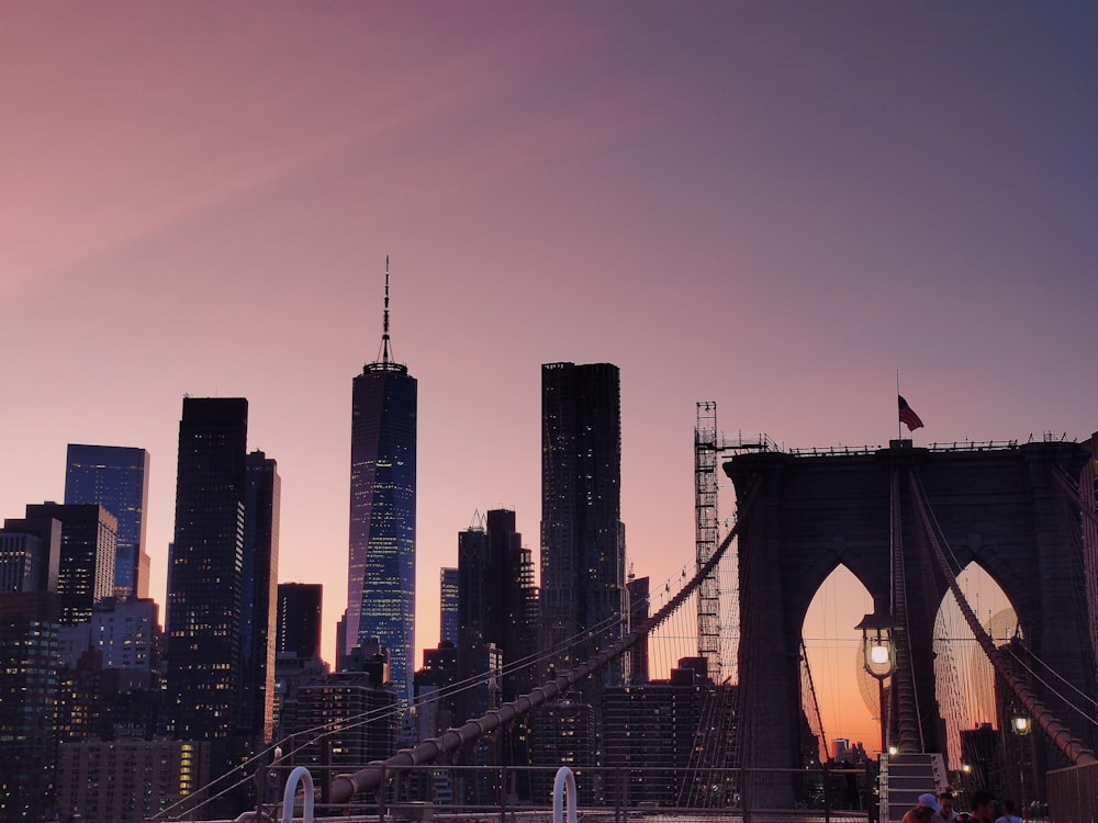 a view of a city skyline with a bridge in the foreground