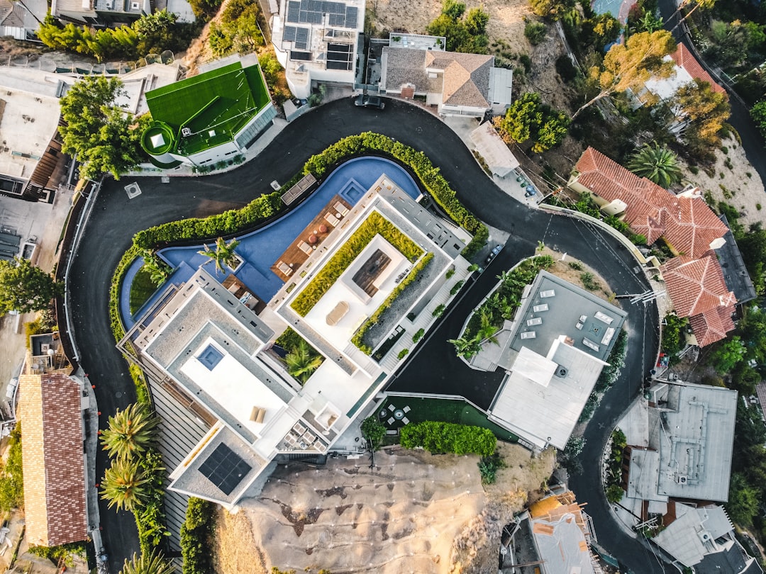an aerial view of a house with a swimming pool, Hollywood Hills Drone sunrise drone shot. ©Ariel blanco