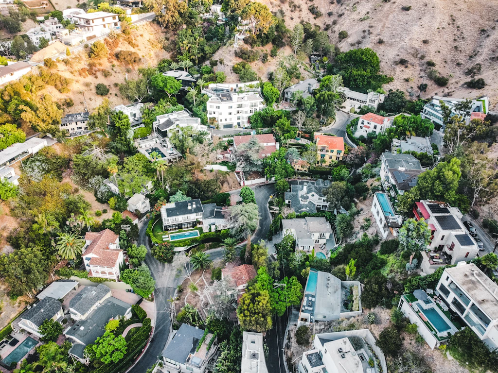 Aerial view of a residential area with surveyed houses and development plots