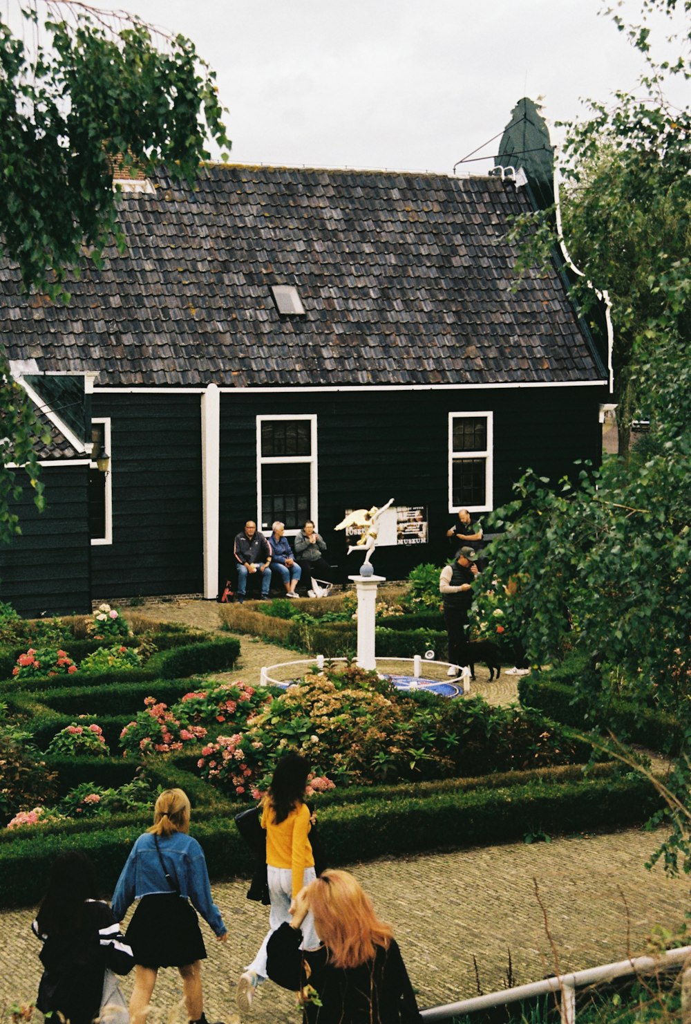 a group of people standing in front of a house