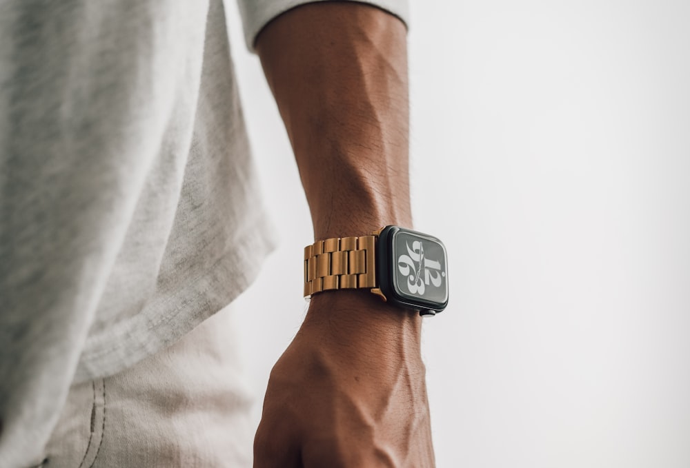 a close up of a person wearing an apple watch