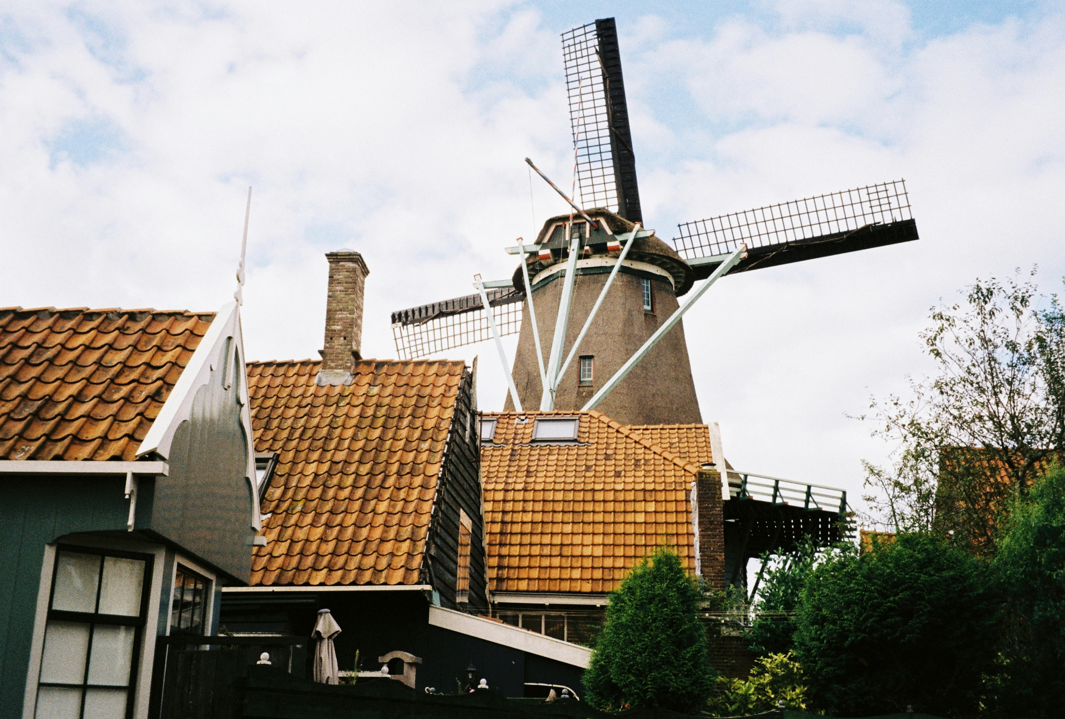 a windmill on top of a building next to a house