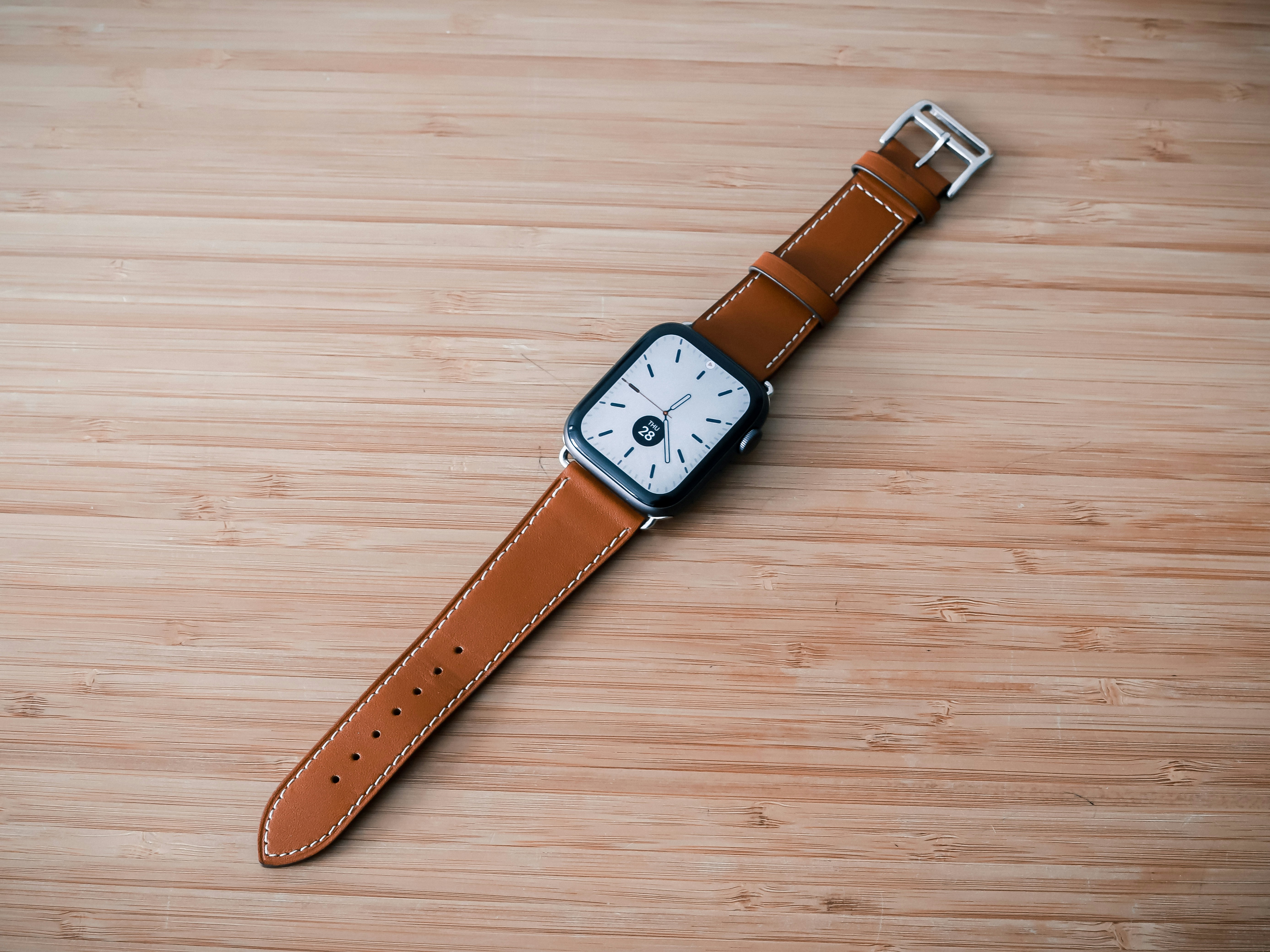 a watch sitting on top of a wooden table
