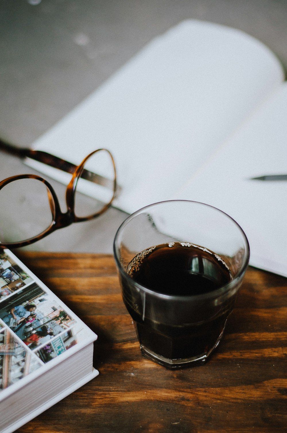 a cup of coffee sitting on top of a wooden table