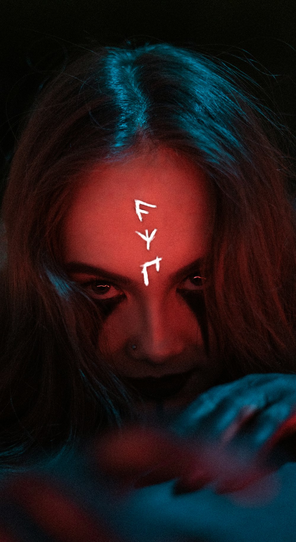 a woman with her face painted red and blue