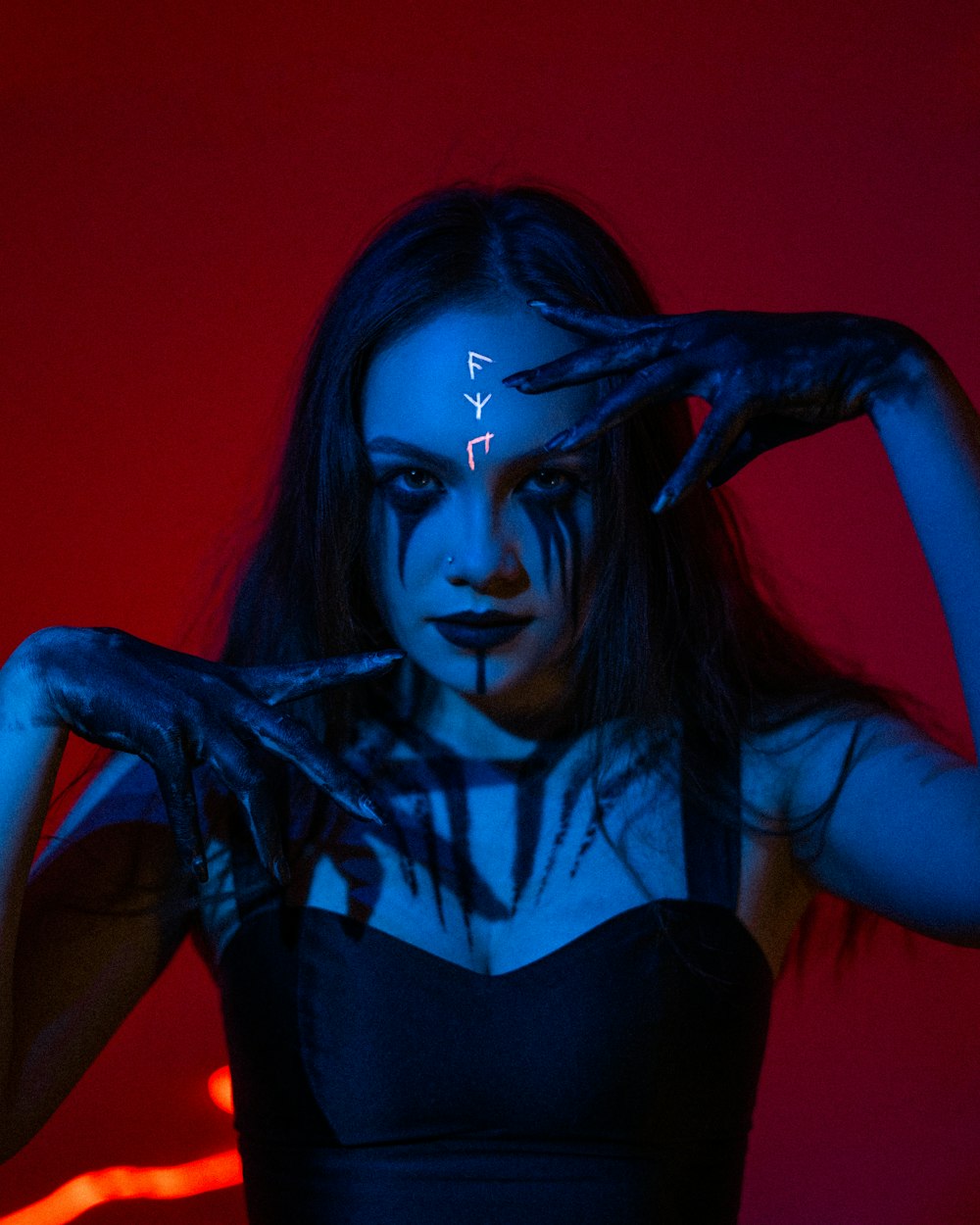 a woman with makeup painted on her face and hands