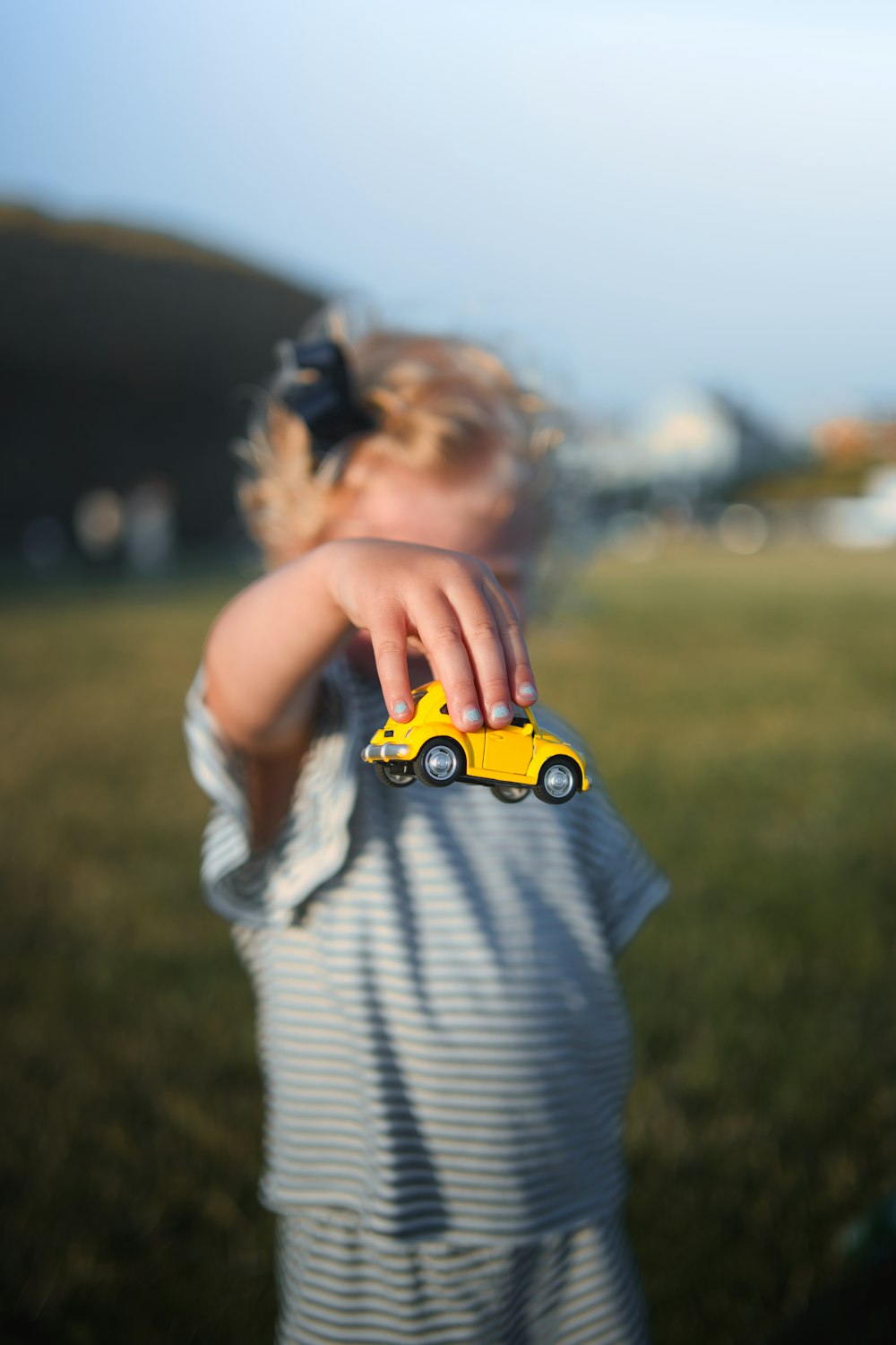 a little girl holding a toy truck in her hand