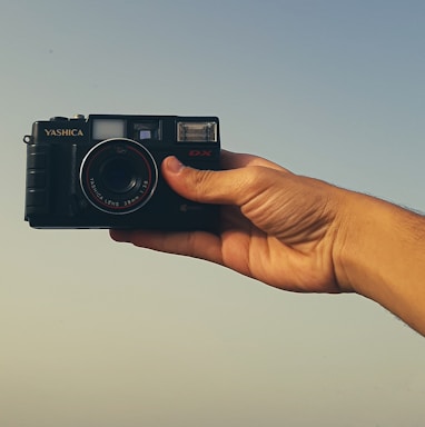 a person holding a camera in their hand