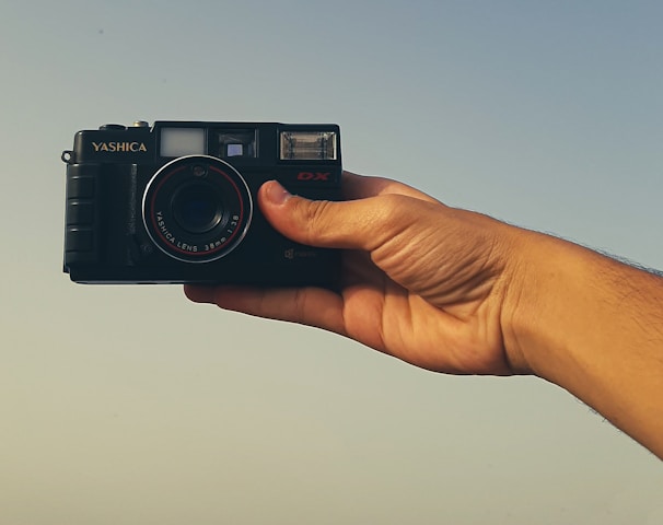 a person holding a camera in their hand