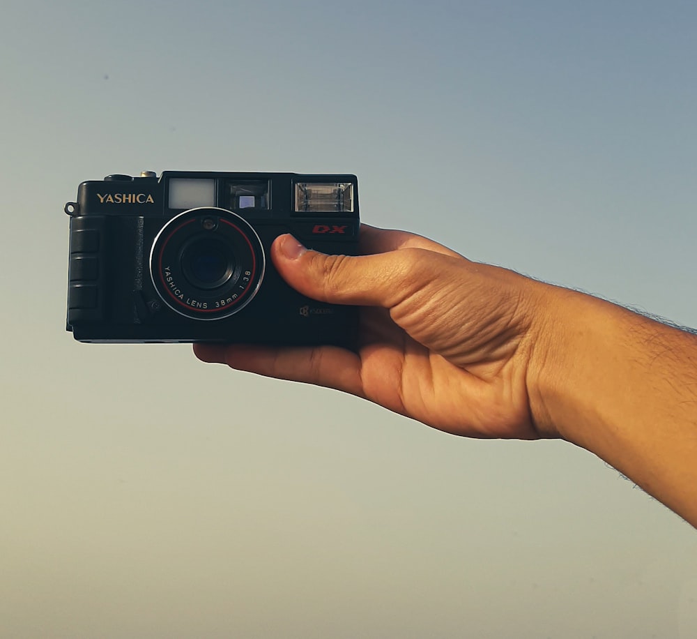 a person holding a camera in their hand