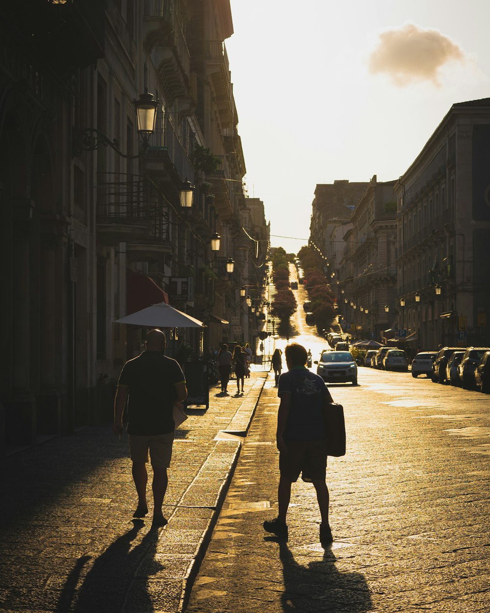 a couple of people that are walking down a street