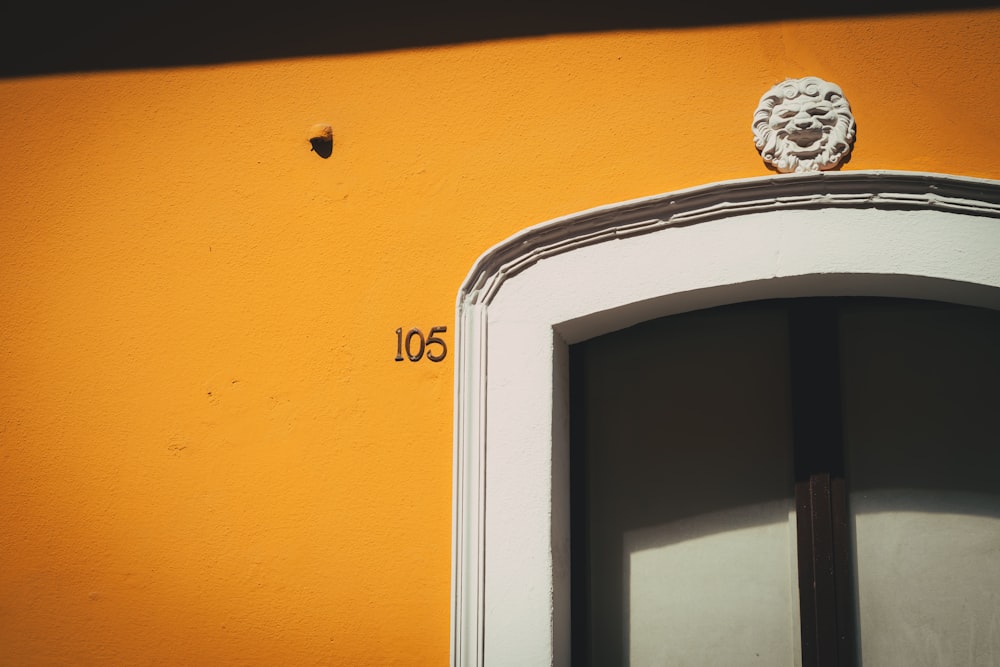 a window with a lion head on the top of it