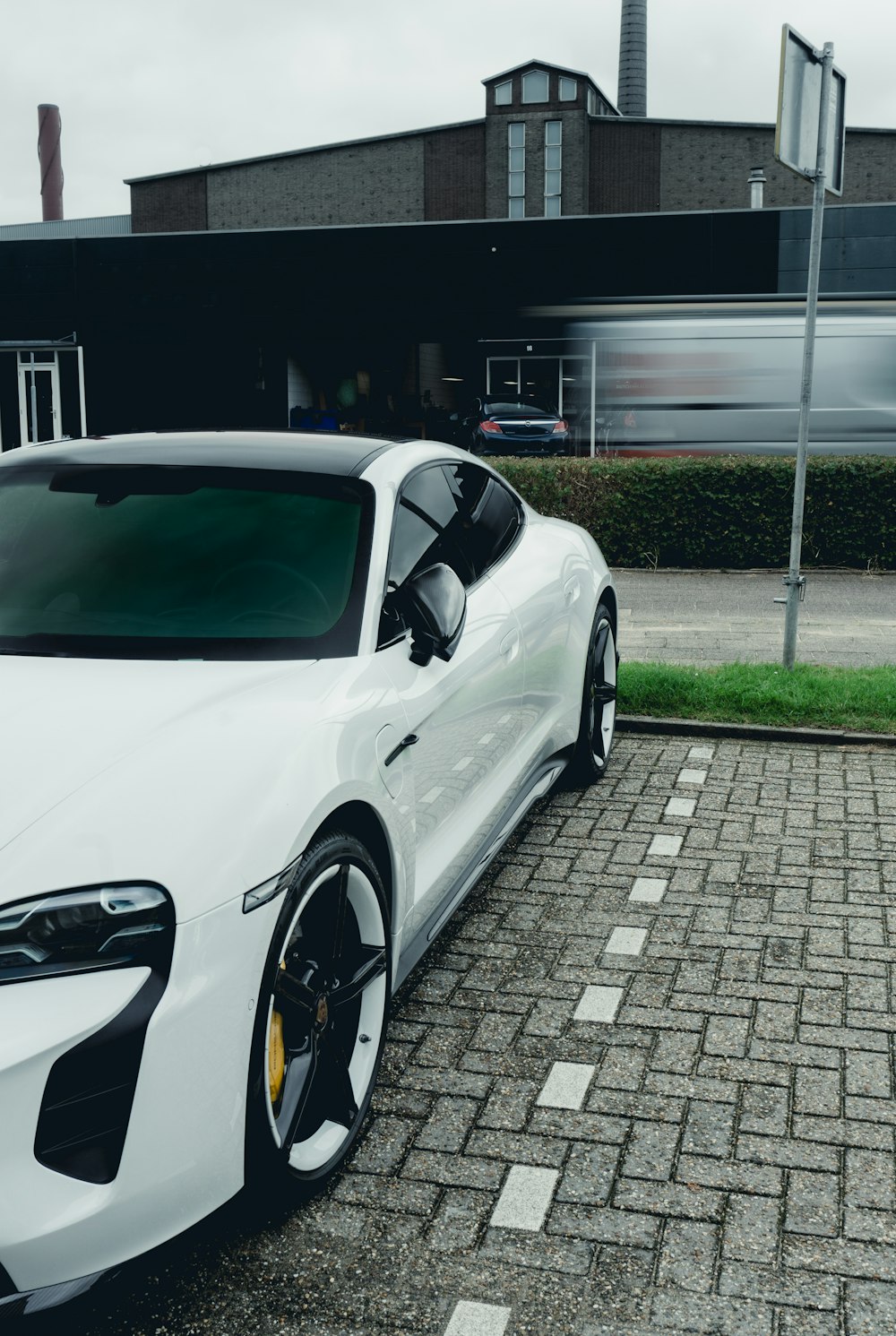 a white sports car parked in front of a building