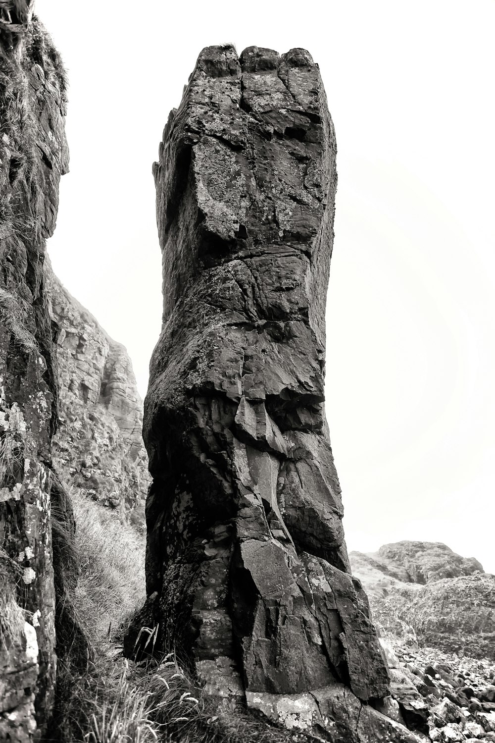 a black and white photo of a rock formation