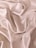 Smooth, flowing folds of shiny, champagne-colored satin fabric create an elegant, luxurious texture.