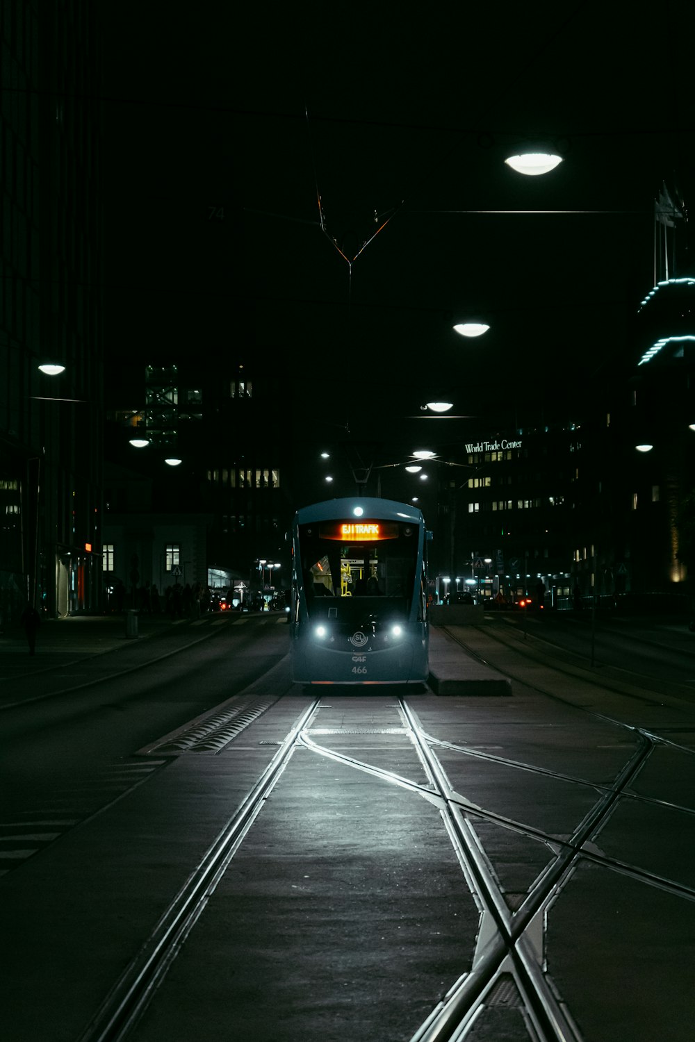 a bus driving down a street at night