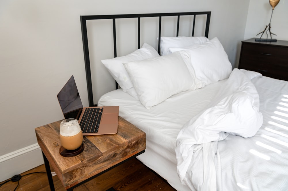 a bed with a laptop on top of it