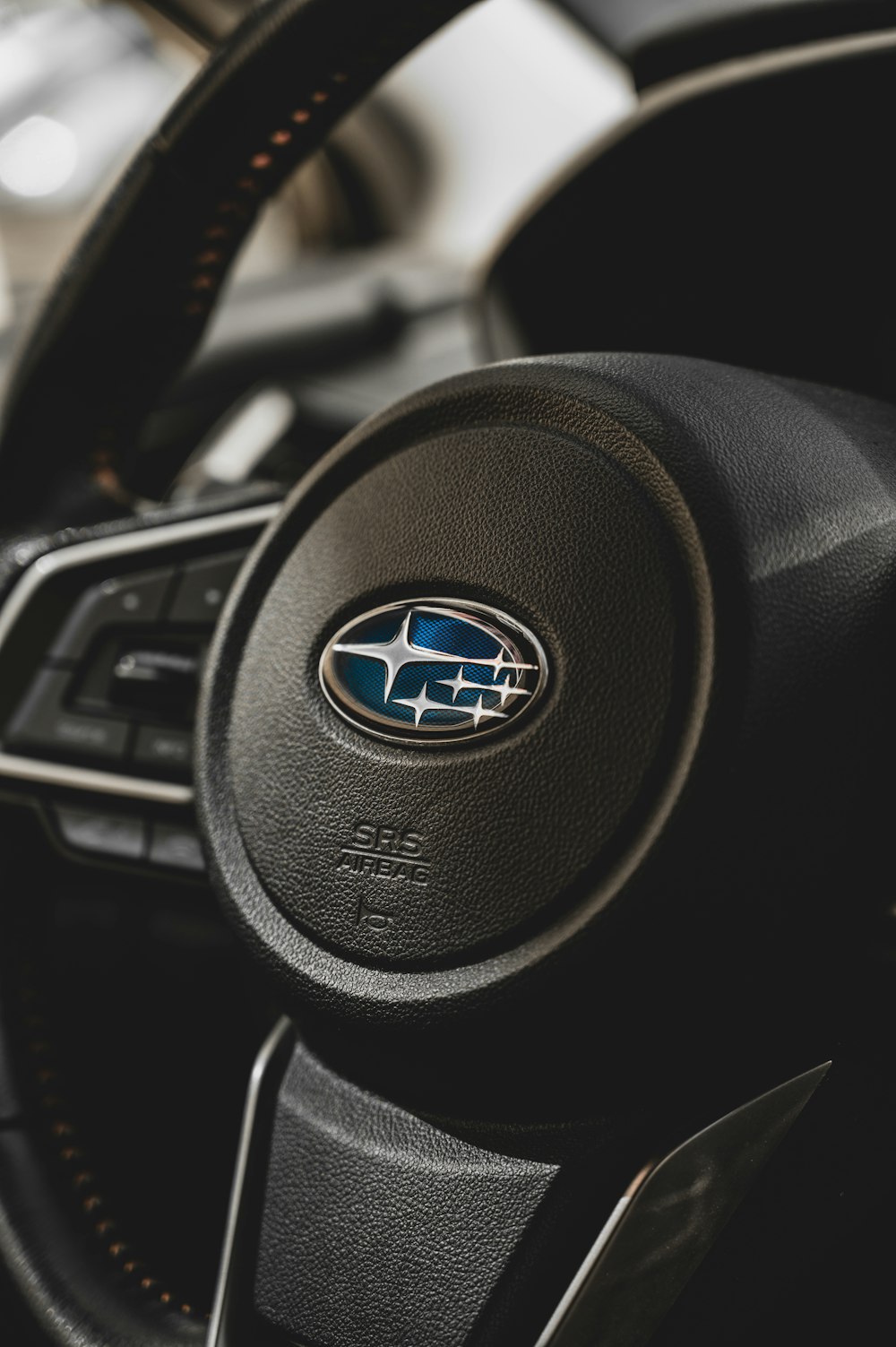 a close up of a steering wheel of a car