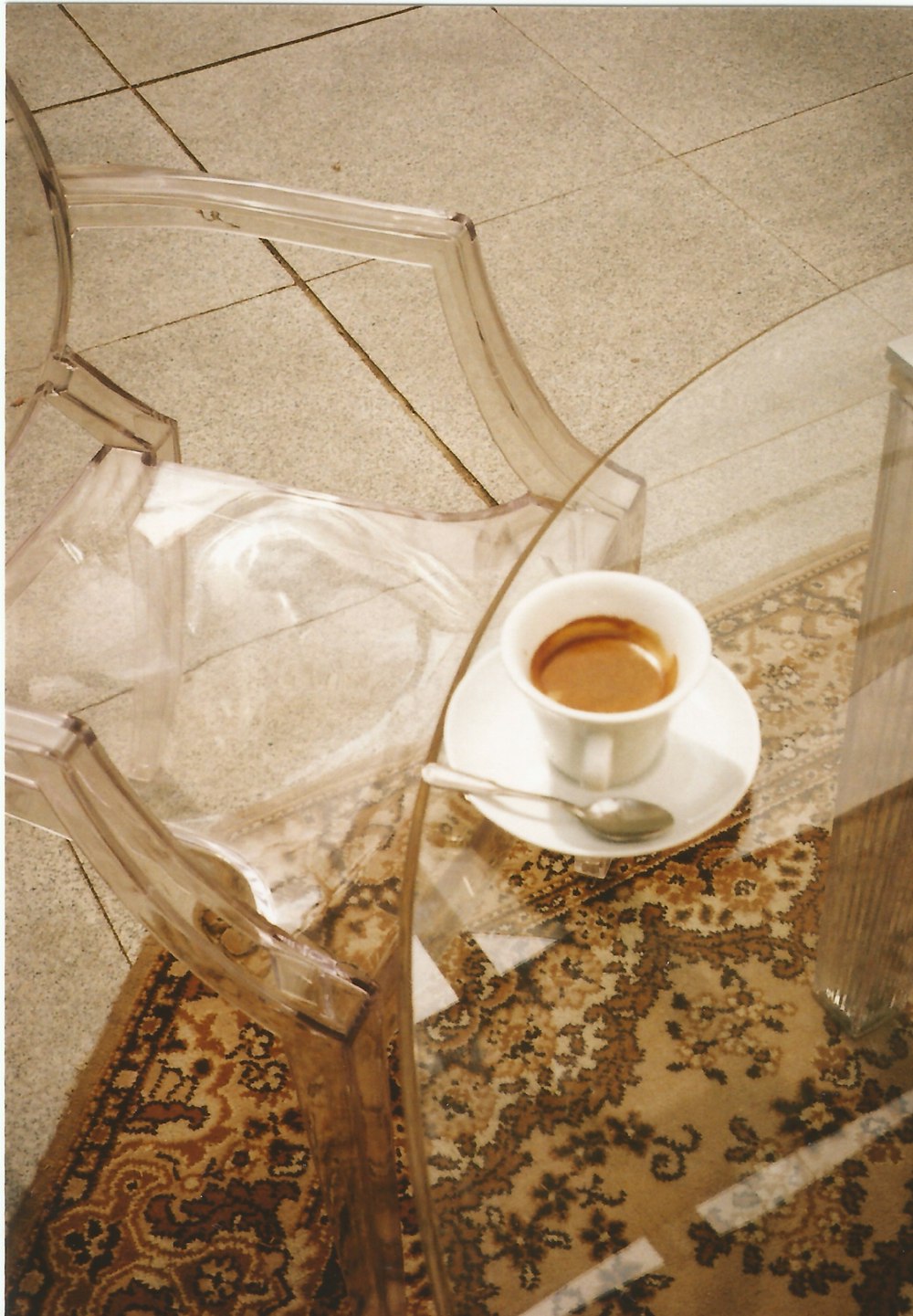 a cup of coffee sitting on top of a glass table