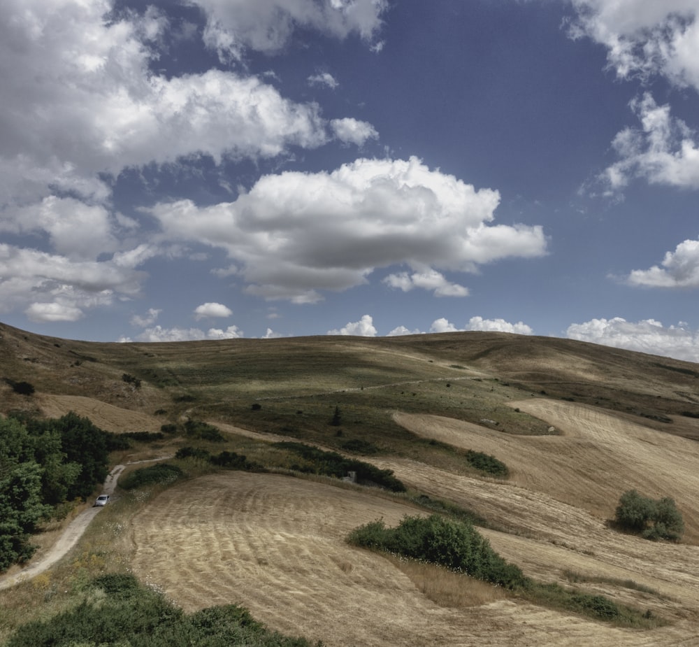 a hill with a dirt road going through it