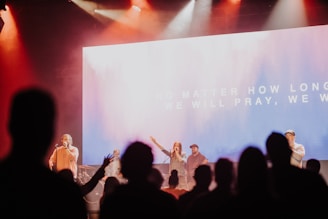 a group of people standing on top of a stage