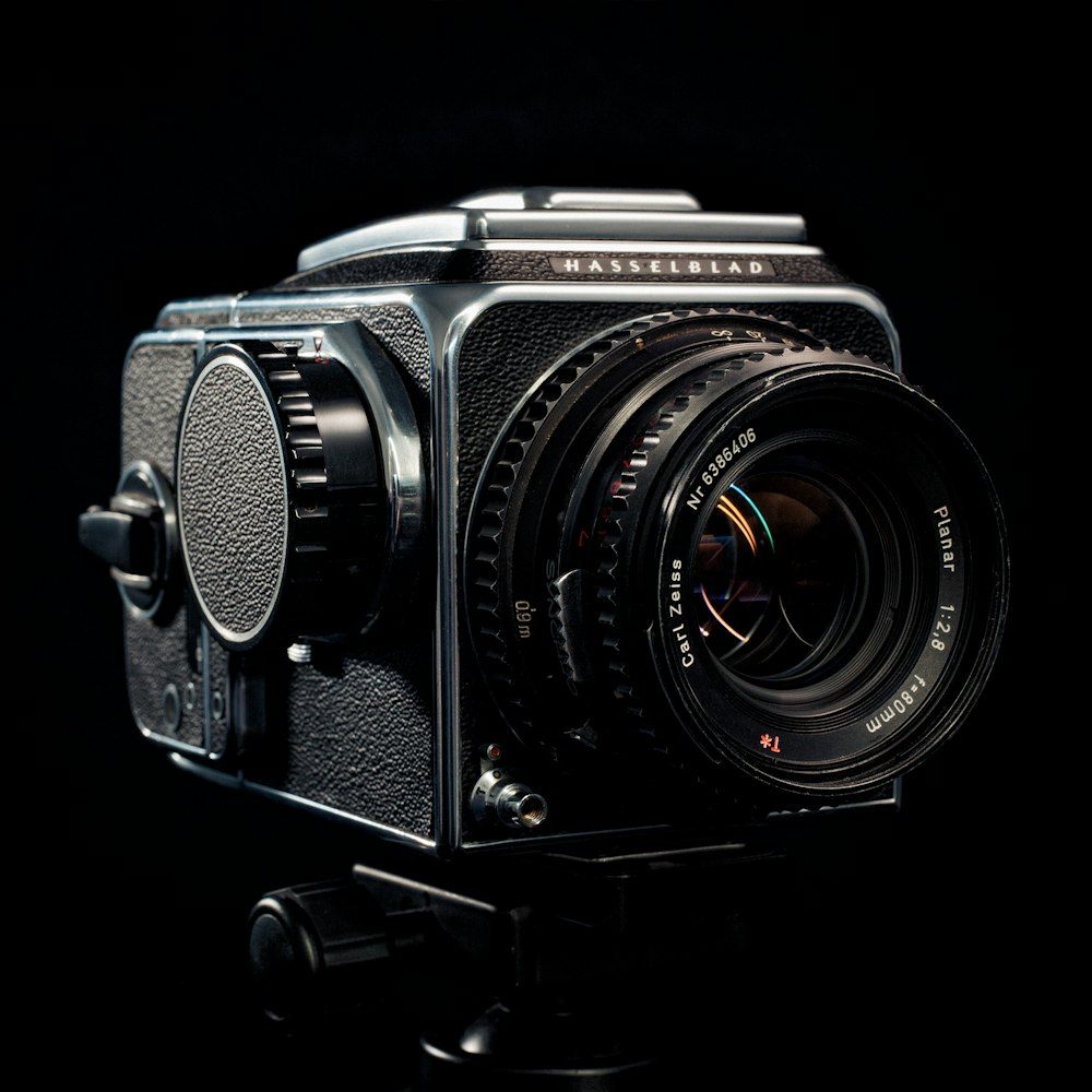 an old fashioned camera with a black background
