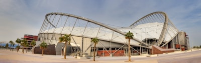 A panoramic view of Morocco's iconic landscapes blending with futuristic stadium designs.
