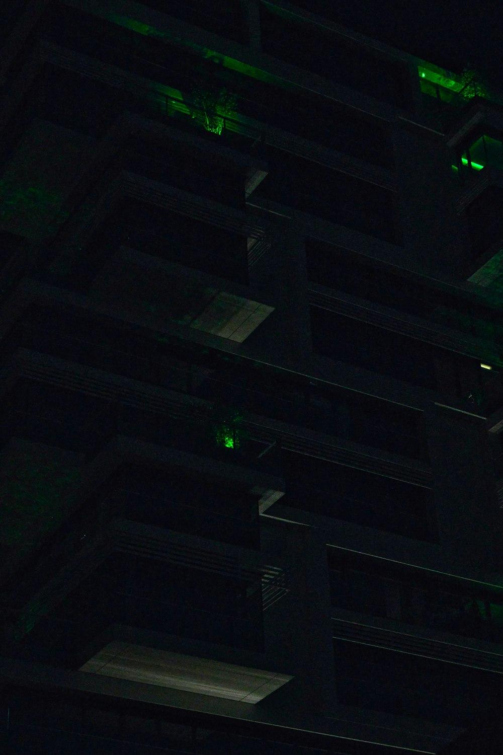 a building lit up with green lights in the dark
