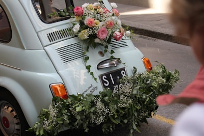 a small car with flowers on the back of it