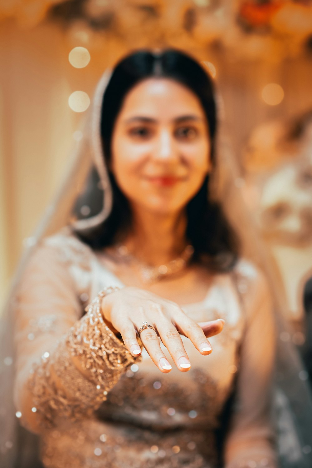 a woman in a wedding dress is holding her hand out