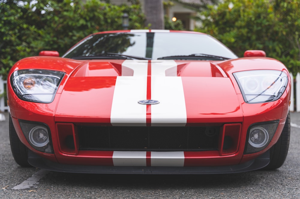 a red and white sports car parked in a parking lot