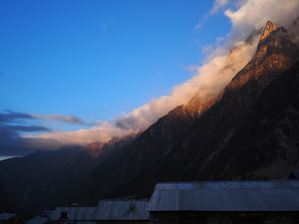 a view of a mountain range with clouds in the sky