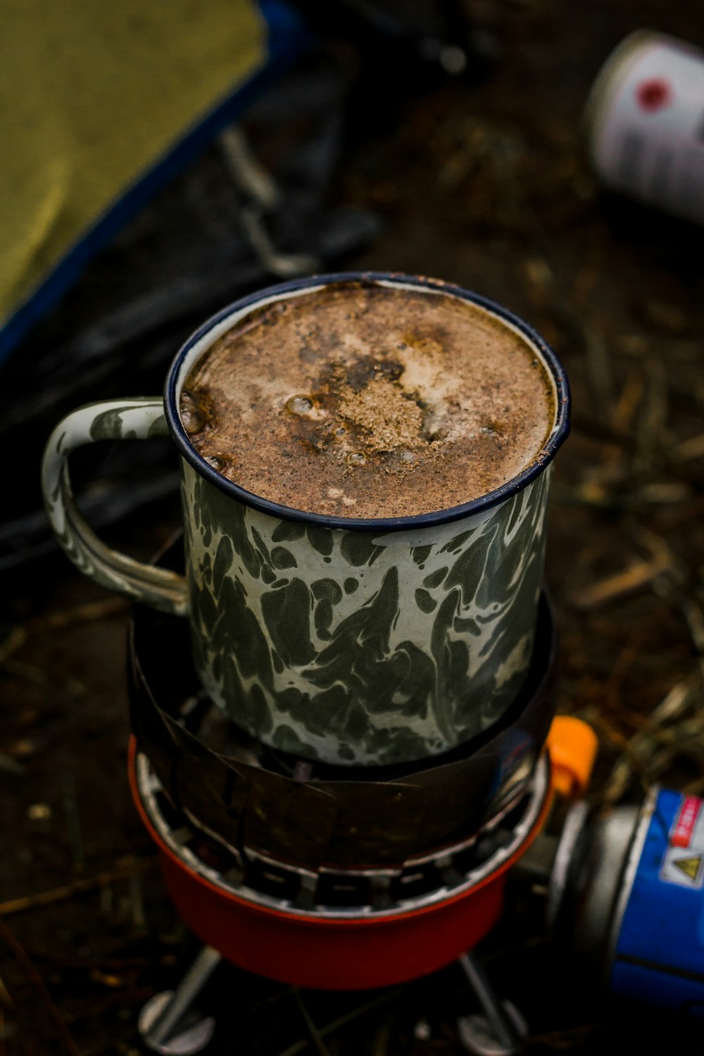 a cup of coffee sitting on top of a stove