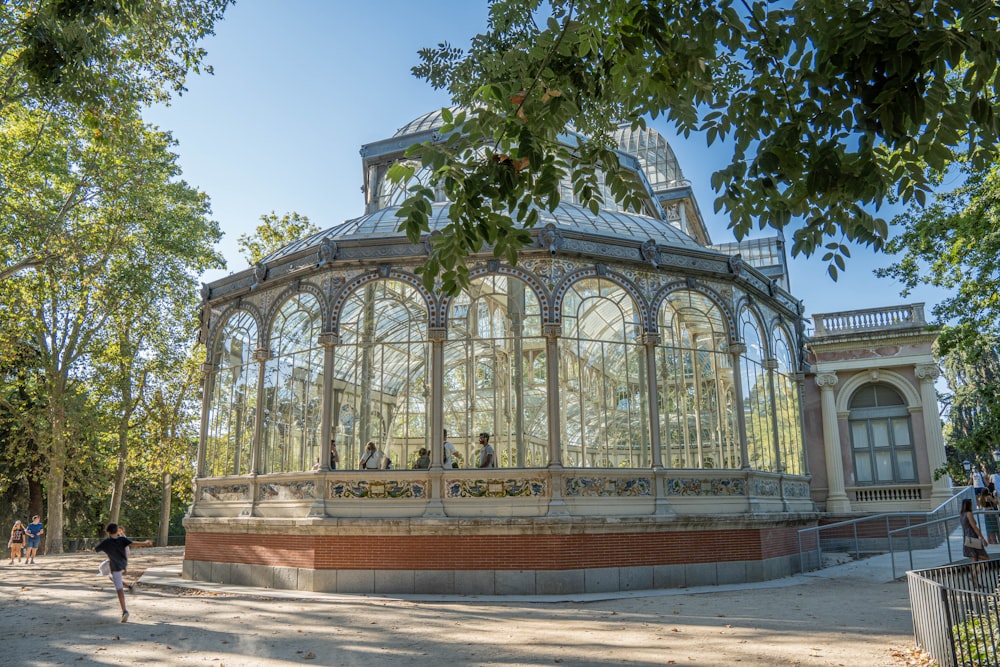 a group of people standing in front of a glass building