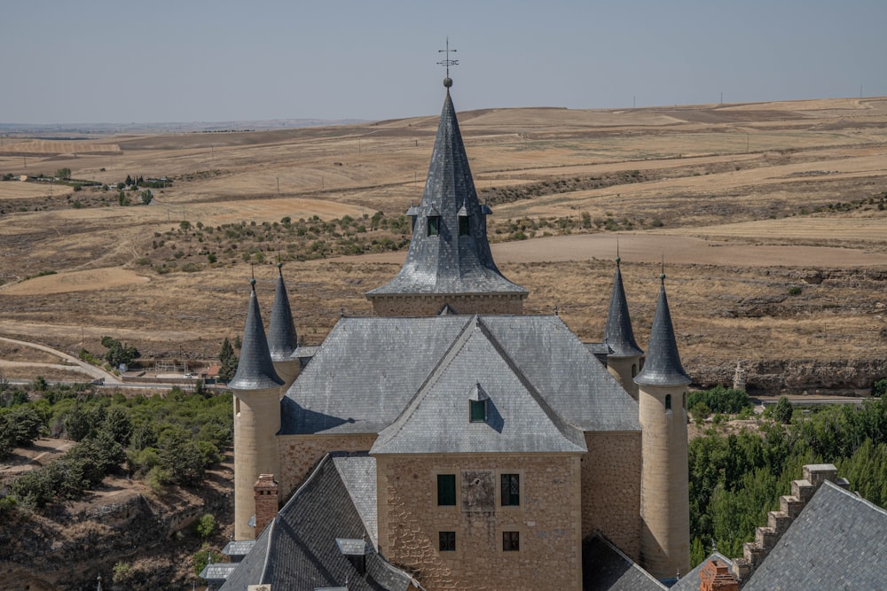 an old church with a steeple in the middle of a field