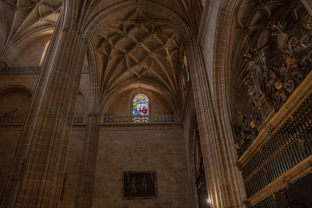 the interior of a cathedral with a stained glass window