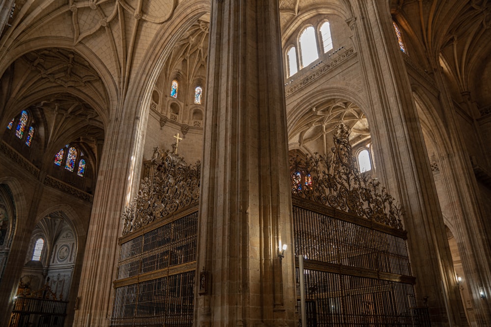 the interior of a large cathedral with many stained glass windows