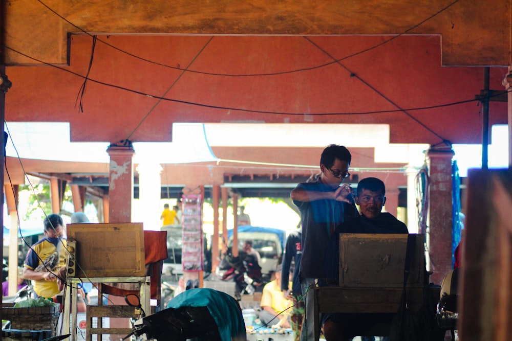 a group of people standing around in a covered area