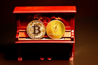 a red box with two gold bitcoins sitting on top of it