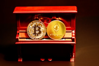 a red box with two gold bitcoins sitting on top of it