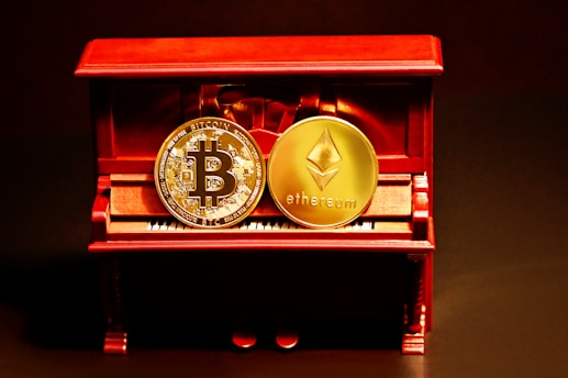 a red box with two gold bitcoins sitting on top of it