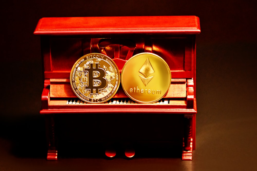 a red box with two gold bitcoins sitting on top of it