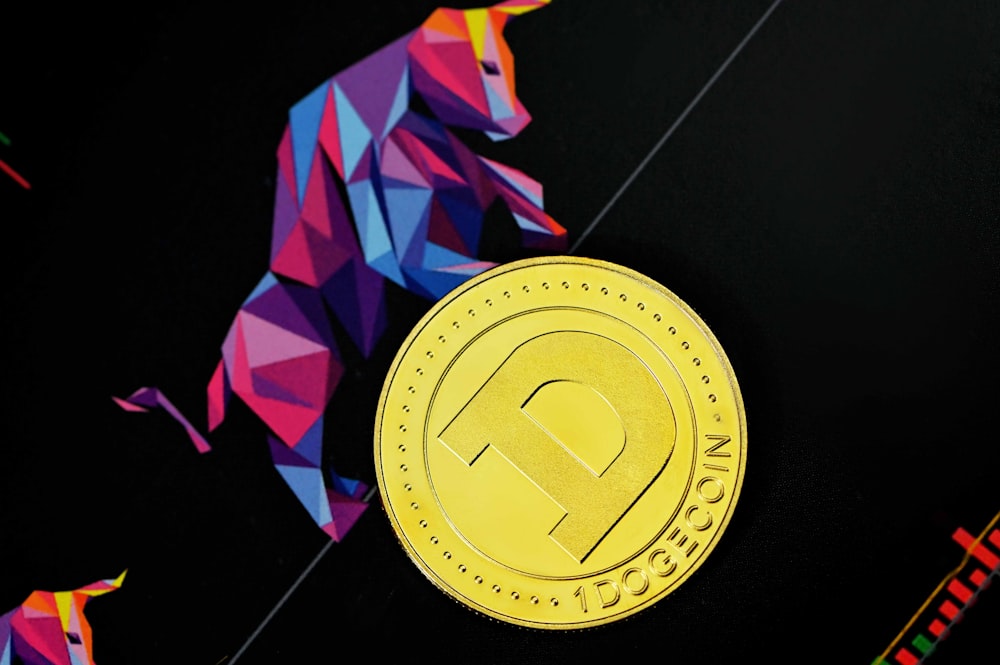 a close up of a gold coin on a black surface
