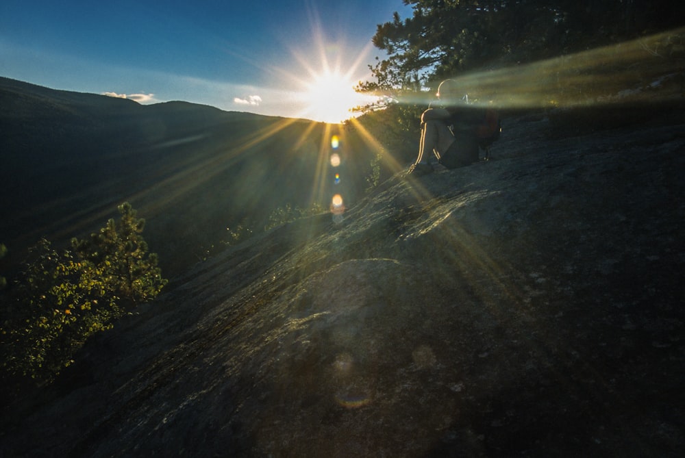 the sun shines brightly over a mountain range