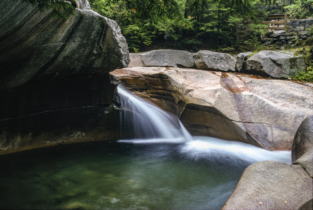 a small waterfall flowing into a pool of water