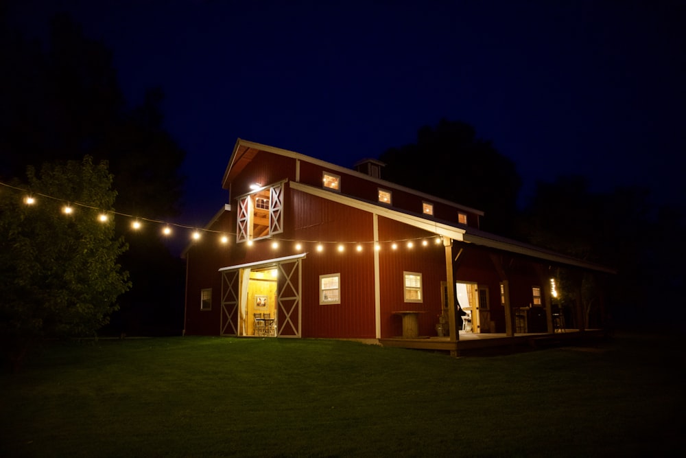 a barn at night with a string of lights