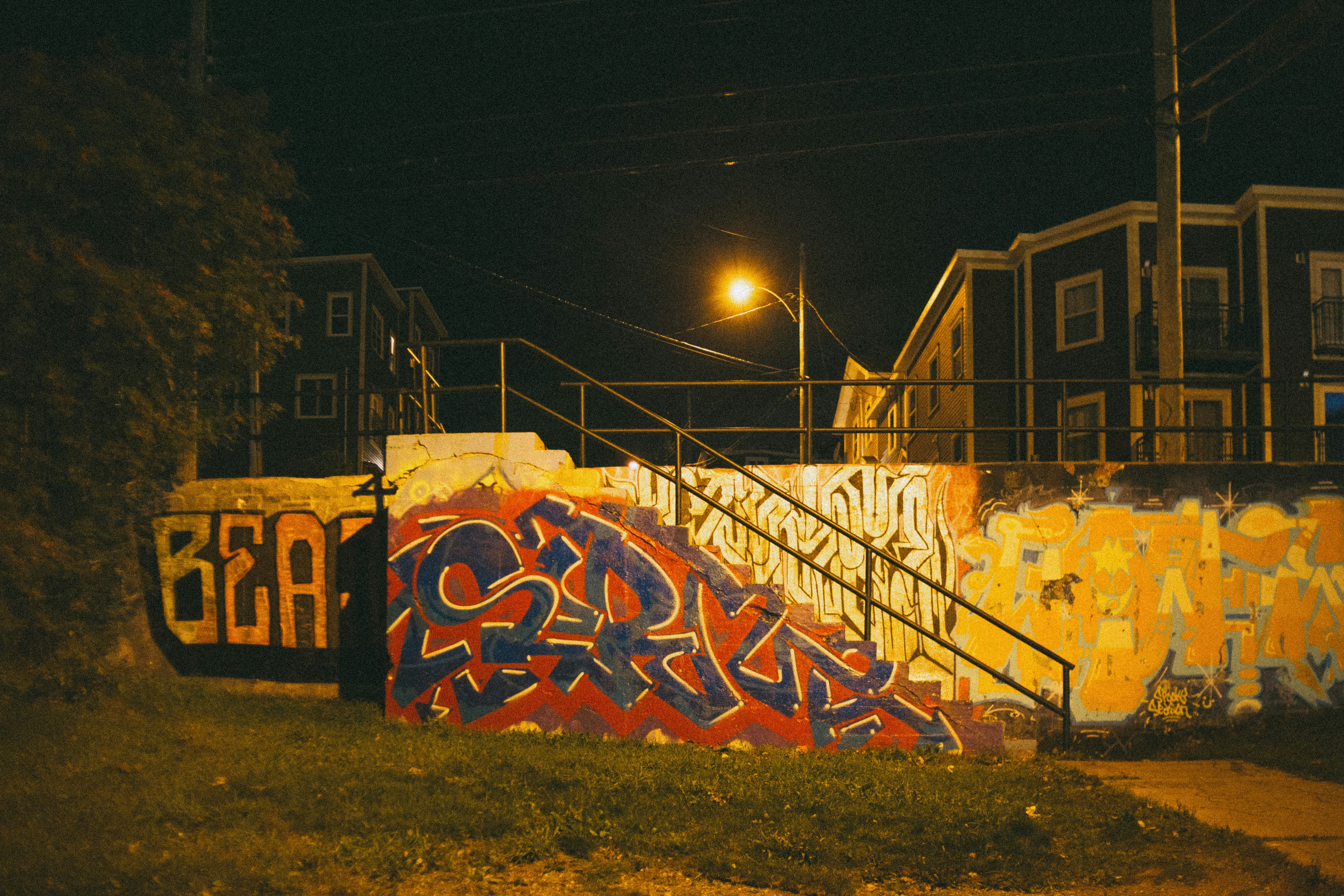a bunch of graffiti on the side of a building
